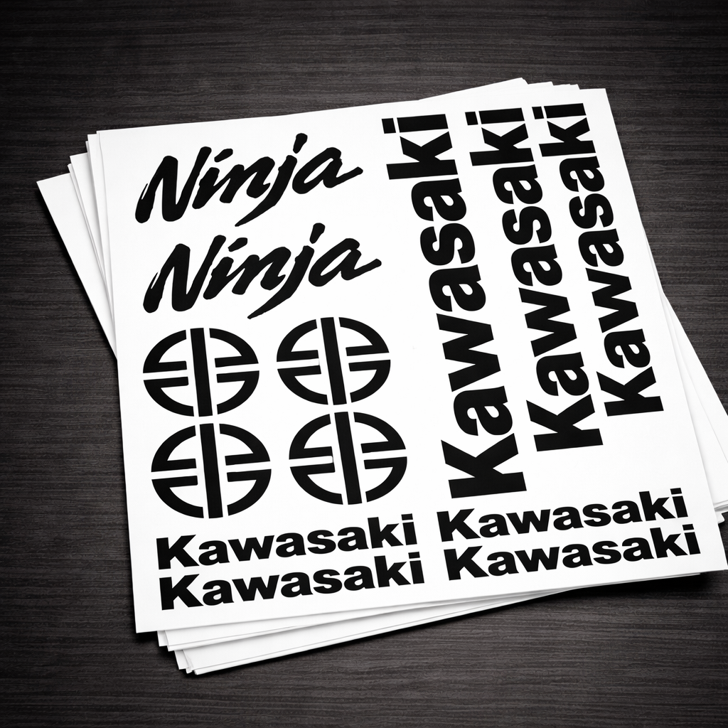 Stack of Kawasaki and Ninja decals on a dark surface