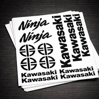 Stack of Kawasaki and Ninja decals on a dark surface