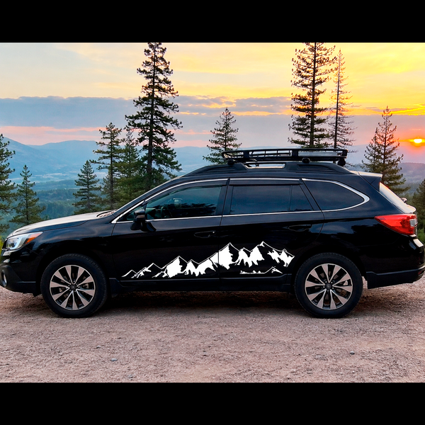 White mountain silhouette vinyl decal installed on the side doors of a black Subaru Outback 2015+ overland vehicle with die-cut no background design.